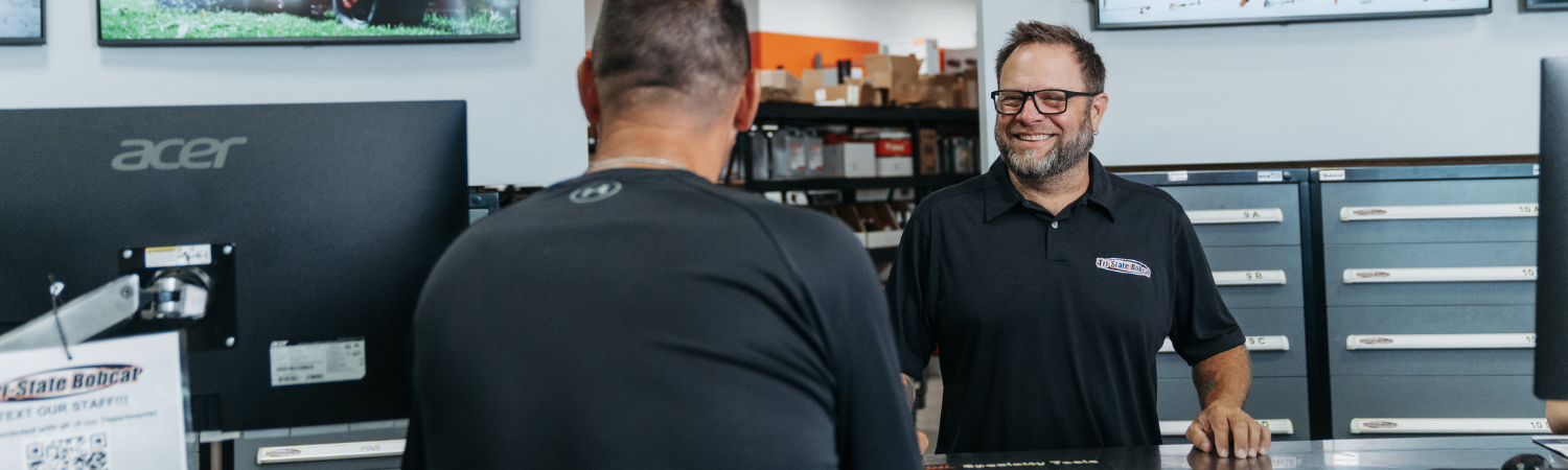 Customer purchasing Bobcat parts at the parts counter