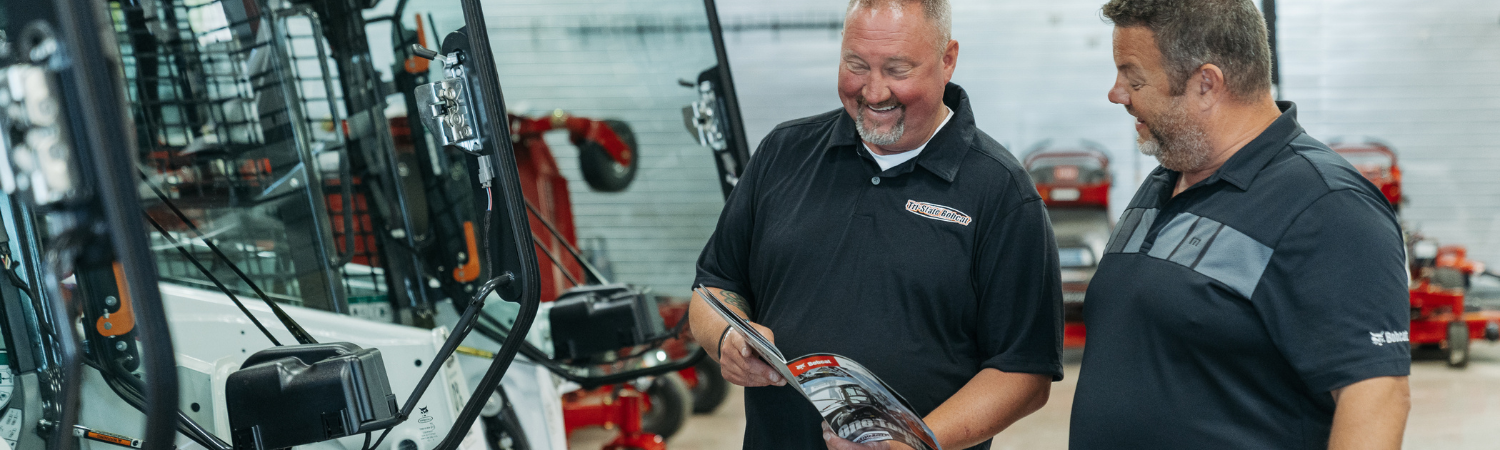 Salesman and customer talking about Bobcat financing options