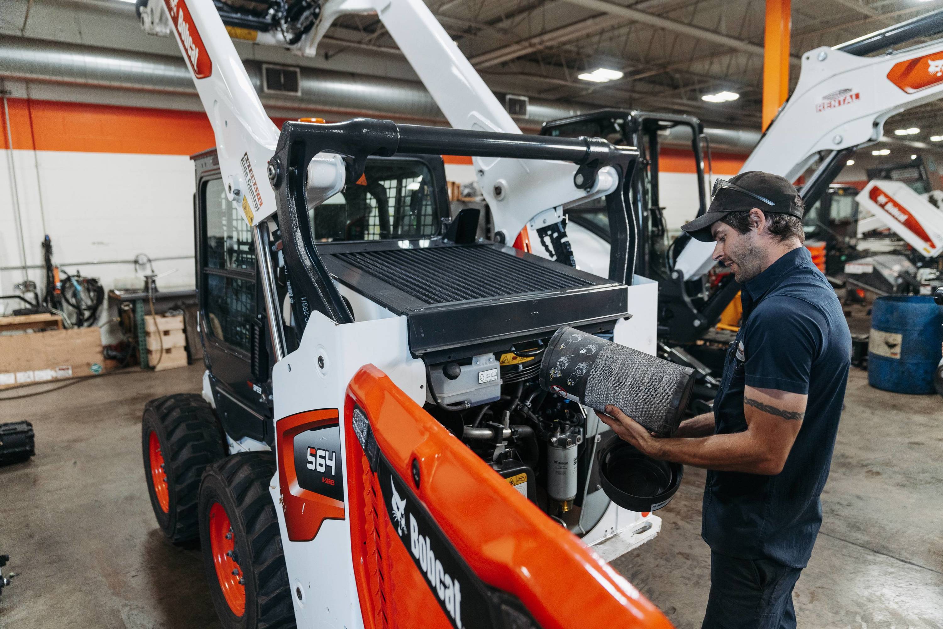 Employee servicing bobcat equipment