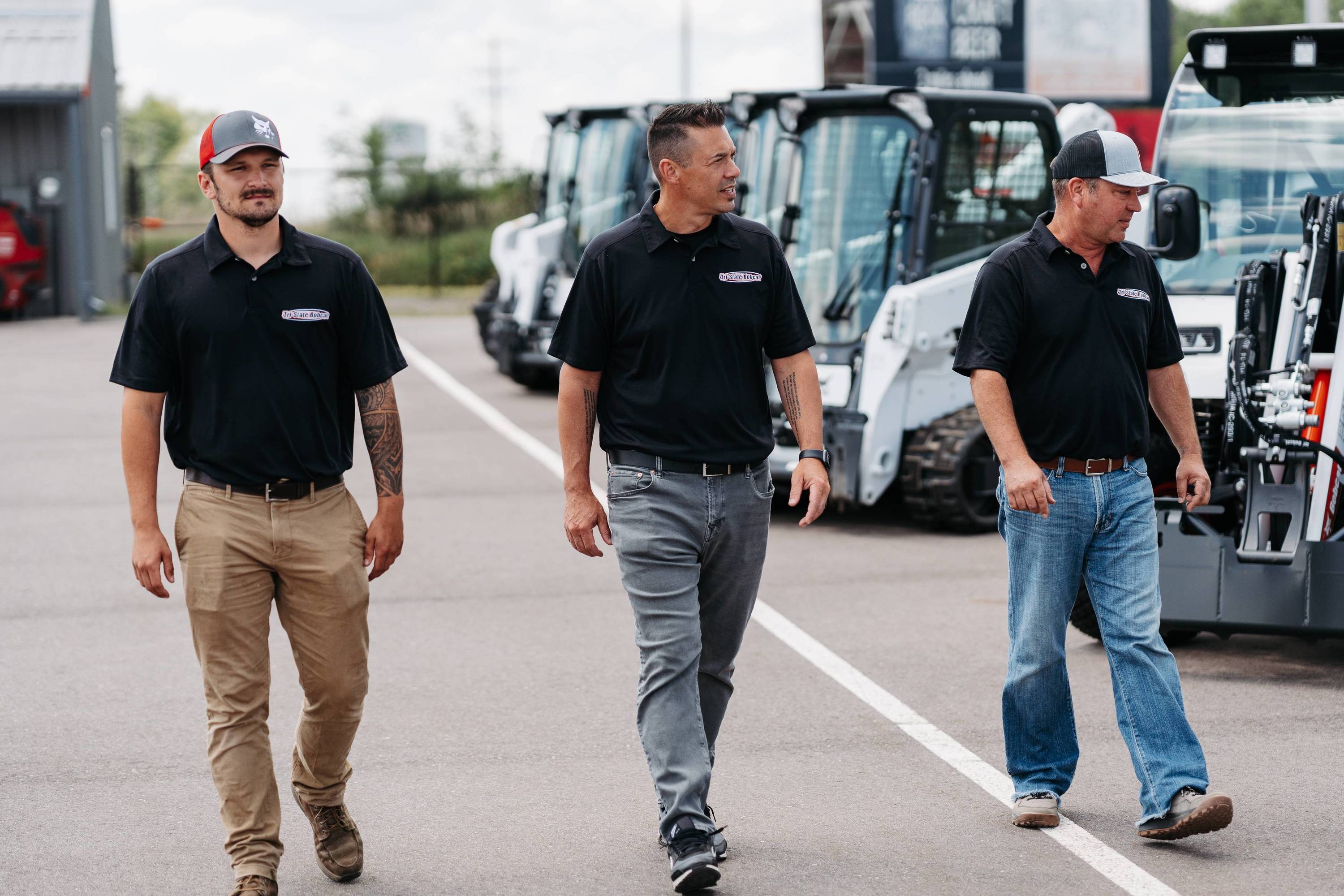 Employees walking past line of Bobcats