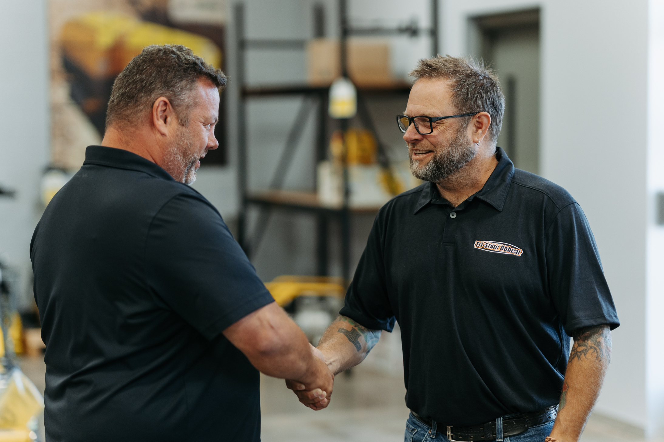 Customer shasking hand with Tri-State Bobcat employee
